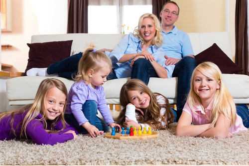 family on carpet playing in corona ca